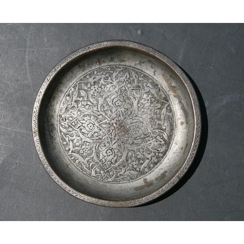 326 - An early Persian shallow dish decorated with flowers, 16.5cms (6.5ins) diameter.