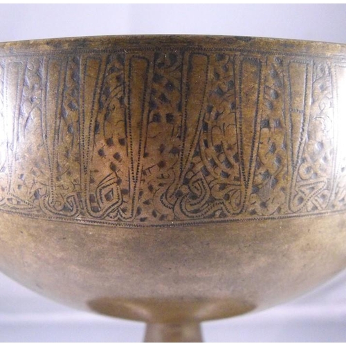 332 - A 12th century Persian Khorassan bronze footed bowl, engraved to the rim with Kufic script in repeti... 