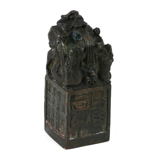 333 - A Chinese bronze seal, the top with a mythical beast, on a square platform with character marks, poe... 