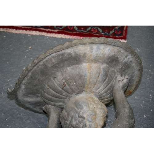 23 - A lead birdbath in the form of a cherub, 70cms (27.5ins) high.