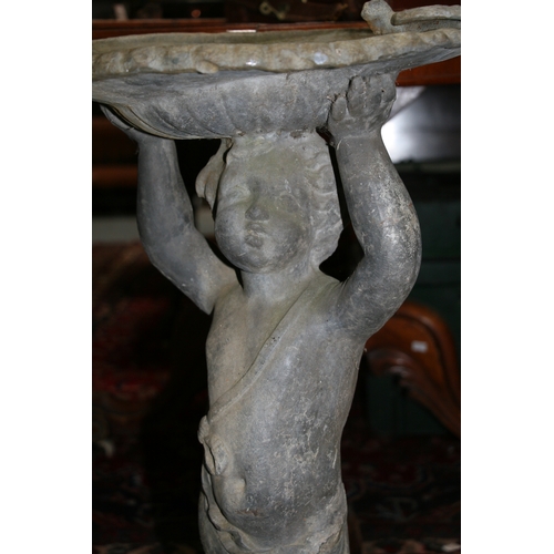 23 - A lead birdbath in the form of a cherub, 70cms (27.5ins) high.