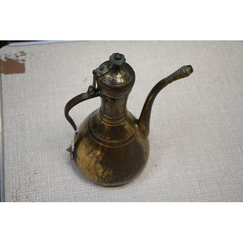 323 - A Turkish gilt copper coffee pot or ewer, 23cms (9ins) high.