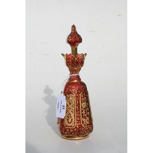 35 - A fine quality 19th century Bohemian cranberry glass scent bottle with gilded overlay decoration, 20... 