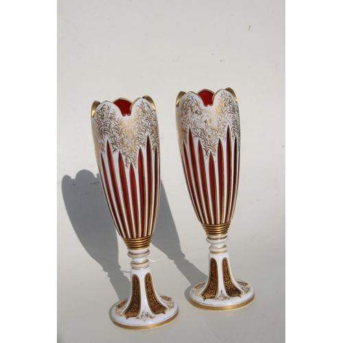 36 - A fine pair of 19th century Bohemian cranberry glass overlaid vases with gilt decoration, 31cms (12.... 