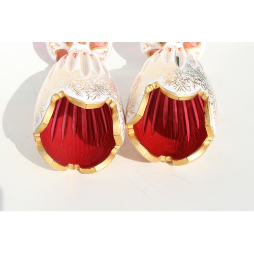 36 - A fine pair of 19th century Bohemian cranberry glass overlaid vases with gilt decoration, 31cms (12.... 