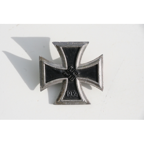 221 - A quantity of WWII badges to include the Iron Cross.