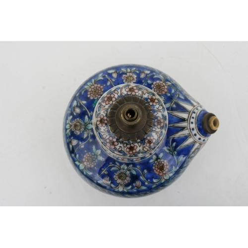 320 - A Persian pottery hookah base decorated with flowers on a blue ground, 21cms (8.25ins) high.