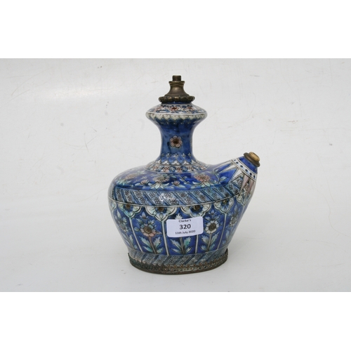 320 - A Persian pottery hookah base decorated with flowers on a blue ground, 21cms (8.25ins) high.