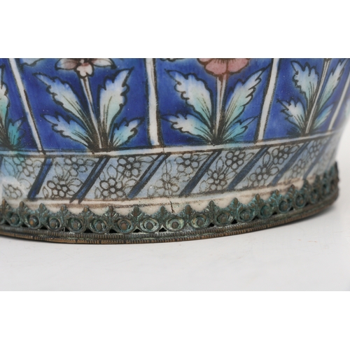 320 - A Persian pottery hookah base decorated with flowers on a blue ground, 21cms (8.25ins) high.