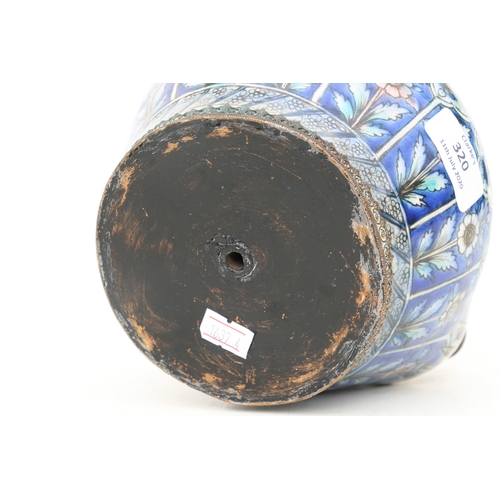 320 - A Persian pottery hookah base decorated with flowers on a blue ground, 21cms (8.25ins) high.