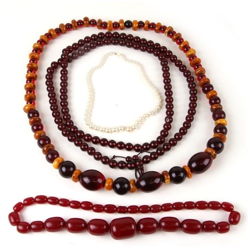 1000 - An amber type graduated bead necklace; together with other similar necklaces and beads.