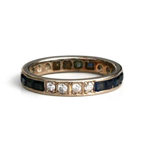 1013 - A diamond and sapphire eternity ring. Approx. UK size P