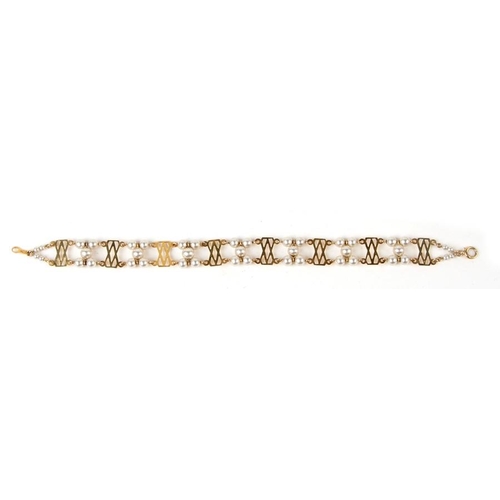 1015 - A 9ct gold and faux pearl bracelet. 17cm (8 ins) long