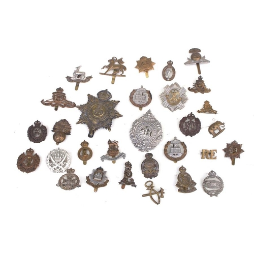 1054 - A quantity of military cap badges to include the Lancashire Fusiliers and Royal Engineers.