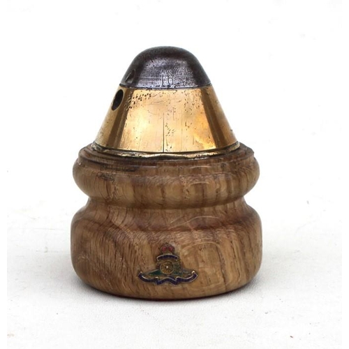 1059 - A WW1 trench art fuse mounted on a turned hardwood base paperweight with applied gilt and enamel Roy... 