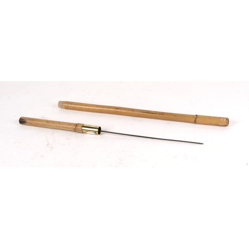 1069 - A cane military swagger stick with concealed square section Stiletto Dagger . Overall length 60.5cms... 