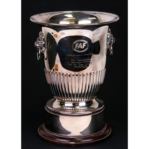 134 - A silver plated two-handled ice bucket, 25cms (9.75ins) high; together with a large silver plated tr... 