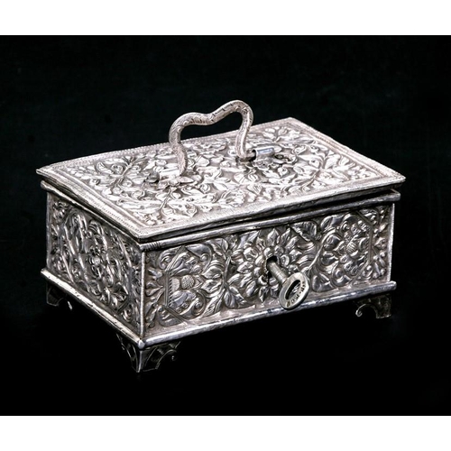 192 - An ornate Indian silver box with all over chased decoration. Embossed to the underside 'Presented by... 