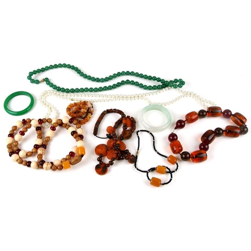 227 - An amber type bead necklace and other necklaces and beads.