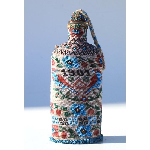 333 - A Boer War 1901 dated Prisoner of War art bead covered bottle with stopper. Overall height 23cms (9i... 