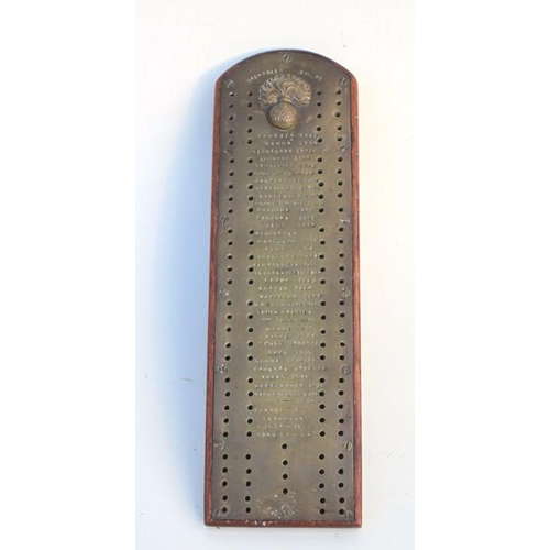 340 - A Grenadier Guards trench art cribbage board of  brass on a hardwood base, inscribed with the regime... 