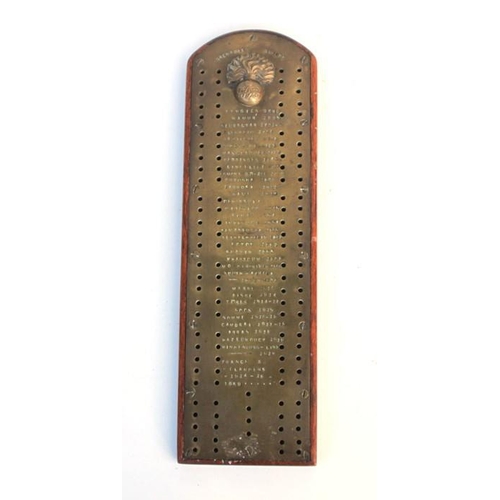 340 - A Grenadier Guards trench art cribbage board of  brass on a hardwood base, inscribed with the regime... 