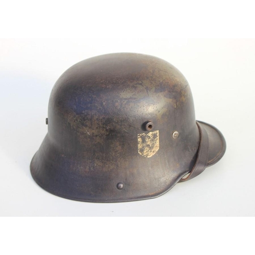 352 - A Third Reich M1916 double decal German helmet with traces of green camoflage paint, with liner and ... 