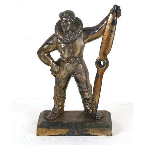 366 - A spelter table lighter in the form of a pilot holding a large propeller, 23cms (9ins) high.Conditio... 