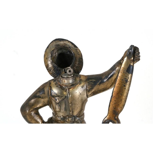 366 - A spelter table lighter in the form of a pilot holding a large propeller, 23cms (9ins) high.Conditio... 