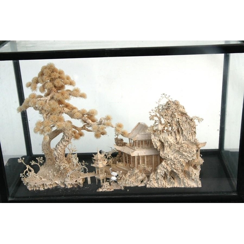 386 - A Chinese cork landscape model display with prunus, buildings and cranes, on an ebonised glazed stan... 