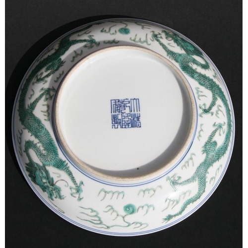 387 - A Chinese famille vert shallow dish decorated with dragons chasing a flaming pearl, blue seal mark t... 