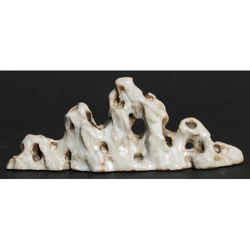 388 - A Chinese glazed brush rest of naturalistic form, 18cms (7ins) long.