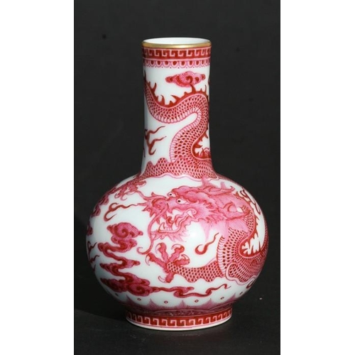 390 - A Chinese porcelain bottle vase decorated pink dragons amongst clouds chasing a flaming pearl, blue ... 