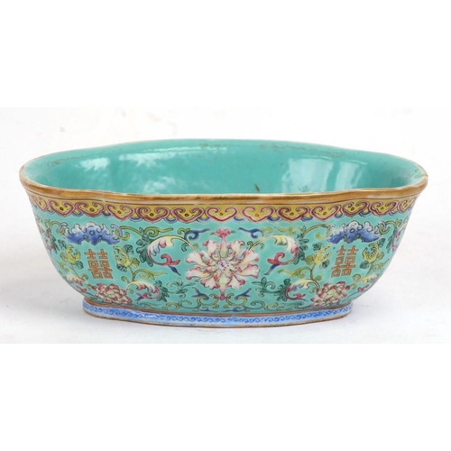 394 - A Chinese famille rose shaped oval bowl decorated with flowers and characters on a turquoise ground,... 