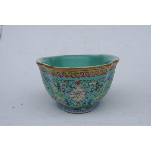 394 - A Chinese famille rose shaped oval bowl decorated with flowers and characters on a turquoise ground,... 