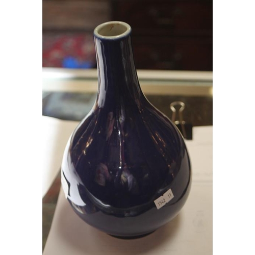 395 - A Chinese blue glazed bottle vase with six character blue mark to the underside, 24cms (9.5ins) high... 