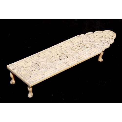 400 - A 19th century Chinese Canton export carved ivory cribbage board decorated with figures within panel... 