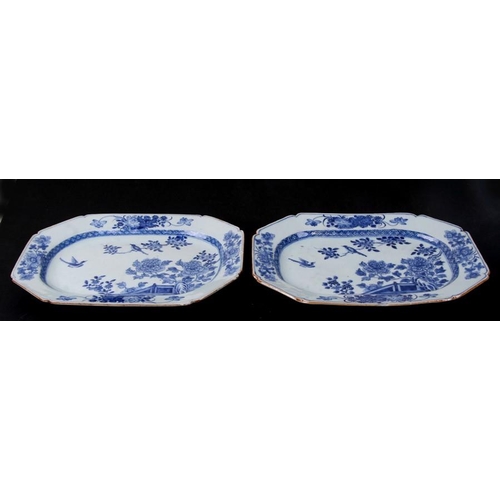 411 - A pair of 18th century Chinese blue and white dishes of elongated octagonal form, decorated birds am... 