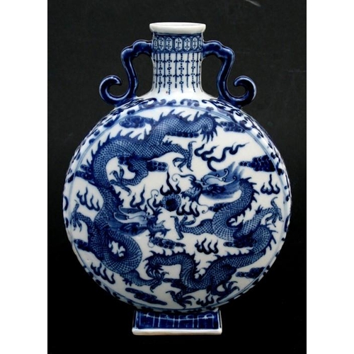 449 - A Chinese blue & white moon flask decorated dragons chasing a flaming pearl and foliate scrolls, fou... 