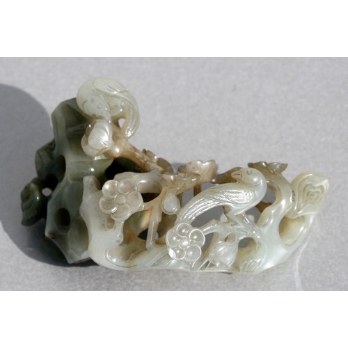 454 - A Chinese jade carving depicting birds amongst flowering foliage, 9cms (3.5ins) long.