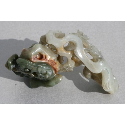 454 - A Chinese jade carving depicting birds amongst flowering foliage, 9cms (3.5ins) long.