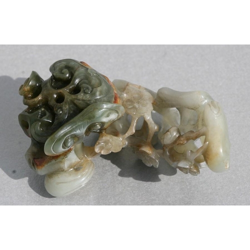 454 - A Chinese jade carving depicting birds amongst flowering foliage, 9cms (3.5ins) long.