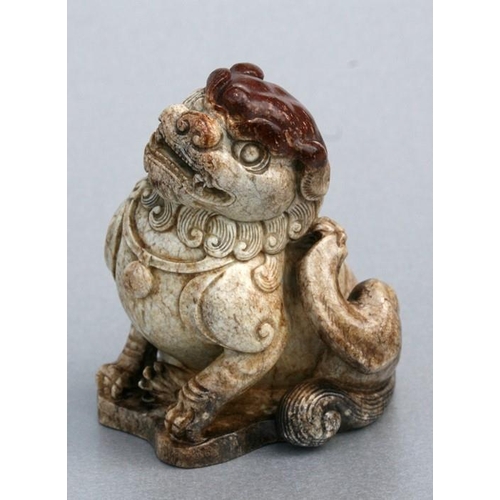 458 - A Chinese figured jade / hardstone temple lion, 10cms (4ins) high.