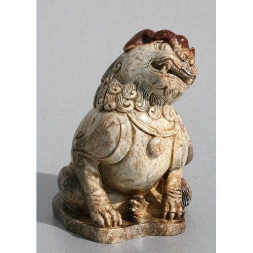 458 - A Chinese figured jade / hardstone temple lion, 10cms (4ins) high.