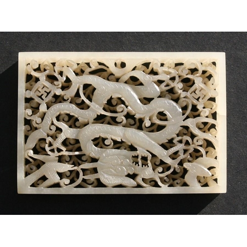 463 - A Chinese pierced rectangular jade plaque depicting a dragon, birds and bats amongst foliage, on a h... 