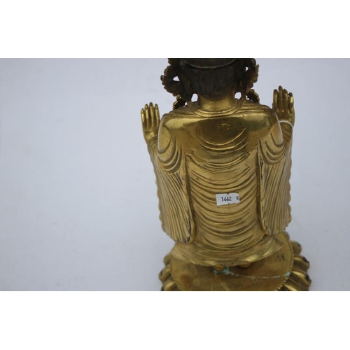 490 - A Chinese gilded bronze standing robed Buddha figure, 33cms (13ins) high.