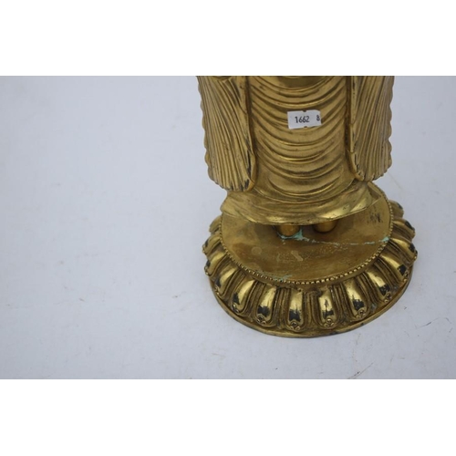 490 - A Chinese gilded bronze standing robed Buddha figure, 33cms (13ins) high.