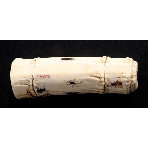 539 - An Oriental carved ivory wrist stand in the form of a bamboo section with shibayama insect decoratio... 