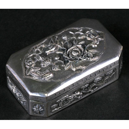 543 - A Chinese silver snuff box of shaped rectangular form with embossed bird, flower and dragon decorati... 