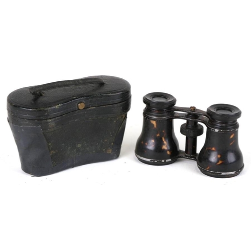 598 - A pair of tortoiseshell opera glasses mounted with silver initials, cased.